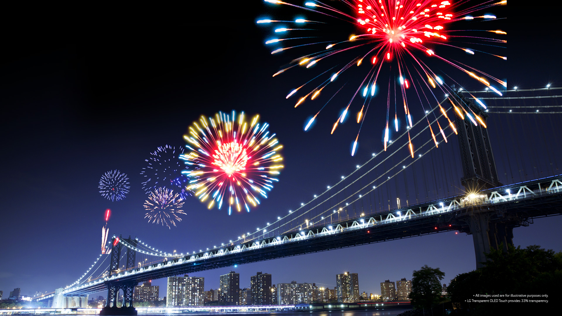 Fireworks displayed on the screen overlaid with the landscape view of the bridge in the city at night in the background.